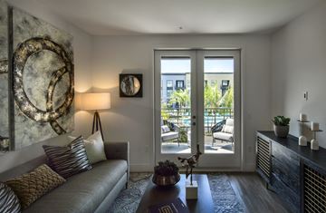San Diego apartment for rent - a living room with a couch and a door to a patio