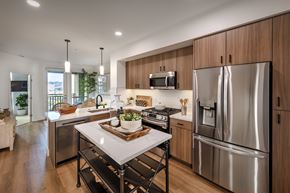 San Diego apartment for rent - A modern kitchen with stainless steel appliances and wooden cabinets.