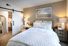 San Diego apartment for rent - A bedroom with a large bed and a painting on the wall.