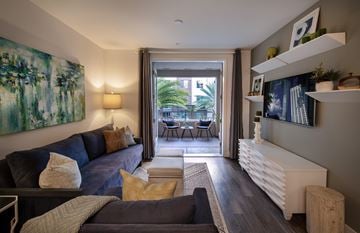 San Diego apartment for rent - A living room with a blue couch and a painting on the wall.
