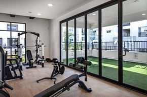 Oceanside apartment for rent - a home gym with exercise equipment and glass windows at Luma at El Corazon Apartments, Oceanside, 92056