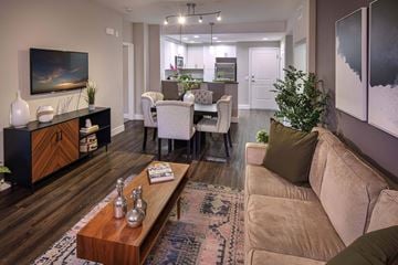 San Diego apartment for rent - A living room with a brown couch and a wooden coffee table.