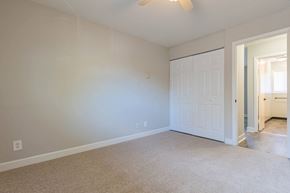 Charlotte apartment for rent - a bedroom with a white door and a carpeted floor