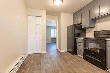 Charlotte apartment for rent - a renovated kitchen with black appliances and wooden floors
