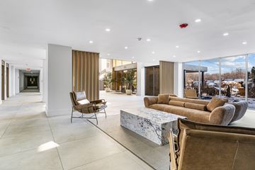 Philadelphia apartment for rent - A modern living room with a marble table and brown couches.