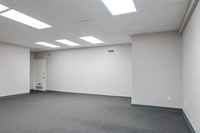 Philadelphia apartment for rent - A white room with a carpeted floor and a door on the left side.