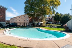 Feasterville-Trevose apartment for rent - A small pool surrounded by a concrete patio and a fence.