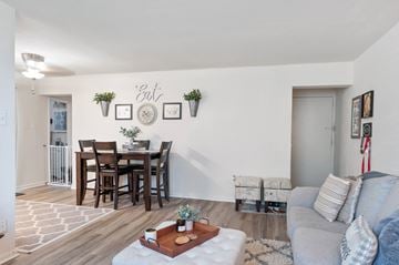 Magnolia apartment for rent - A living room with a dining table and chairs.