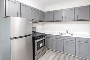 Magnolia apartment for rent - A kitchen with a stainless steel refrigerator and oven.