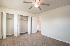 Baltimore apartment for rent - A room with a ceiling fan and carpeted floor.
