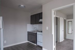 Philadelphia apartment for rent - A kitchen with white appliances and dark wood cabinets.