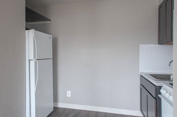 Philadelphia apartment for rent - A white refrigerator stands in a kitchen with a white stove and sink.