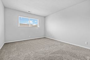 Hampton apartment for rent - A room with a carpeted floor and a window showing a building outside.