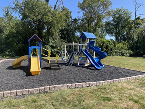 Woodlawn apartment for rent - a playground with two slides and a swing set on a sunny day