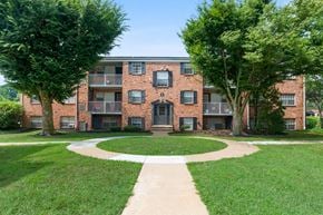 Wilmington apartment for rent - A brick building with a black door and windows.