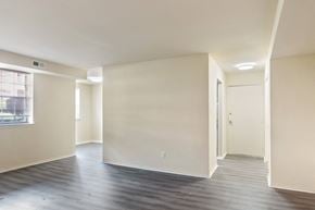 Wilmington apartment for rent - A spacious room with a door on the right and a window on the left.