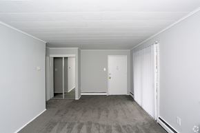 Morrisville apartment for rent - A room with a carpeted floor and a sliding glass door.
