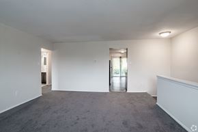 Morrisville apartment for rent - A large empty room with a carpeted floor and white walls.