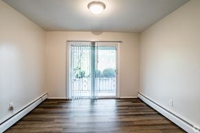 Morrisville apartment for rent - A room with a sliding glass door leading to a balcony.