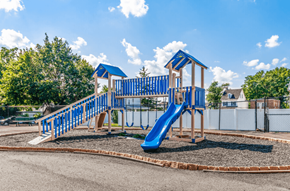 Philadelphia apartment for rent - A playground with a blue slide and wooden structure.