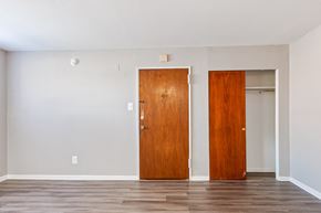 Philadelphia apartment for rent - Two wooden doors in a room with a light grey wall.
