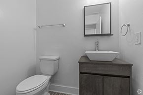 Norfolk apartment for rent - a bathroom with a toilet and a sink and a mirror