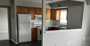 Philadelphia apartment for rent - A kitchen with a white refrigerator and wooden cabinets.