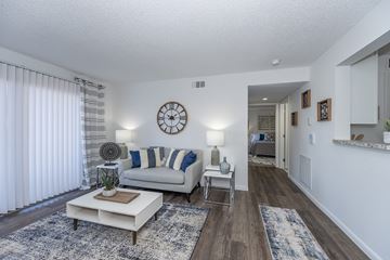 Zanesville apartment for rent - A living room with a white couch and a clock on the wall.