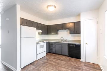 Madison apartment for rent - A kitchen with white appliances and wooden floors.