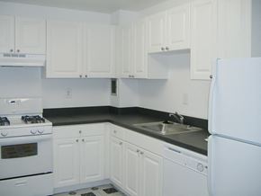 Philadelphia apartment for rent - A white kitchen with a black countertop and white appliances.