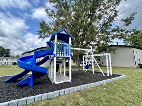 Madison apartment for rent - a playground with a blue slide and swing set