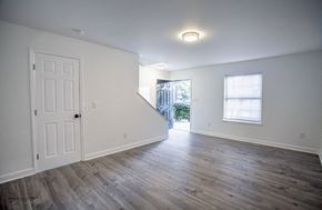 Charlotte apartment for rent - the living room of an empty house with a white wall and wooden floors