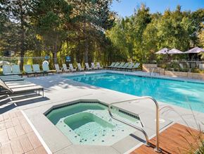 Seattle apartment for rent - a swimming pool with a hot tub and chairs around it