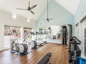 Seattle apartment for rent - a gym with weights and cardio equipment on a hard wood floor
