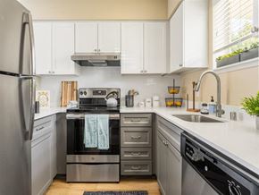 Seattle apartment for rent - a kitchen with stainless steel appliances and white cabinets