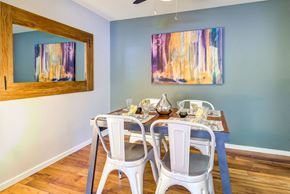 Seattle apartment for rent - a dining room with a table and chairs and a painting on the wall
