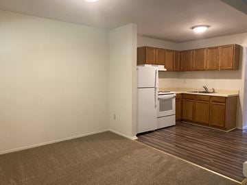 Aberdeen apartment for rent - an empty kitchen with white appliances and wooden cabinets