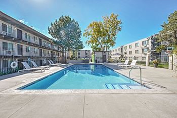Our apartments have a swimming pool and a patio with chairs