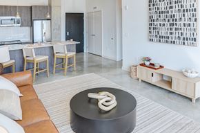 New Haven apartment for rent - A modern kitchen with a black table in the middle at The Anthem at Square 10 Apartments, New Haven, 06510