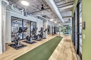 Bridgeport apartment for rent - a gym with treadmills and other exercise equipment in a room with glass doors