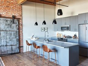Norwalk apartment for rent - a kitchen with a blue island and three stools