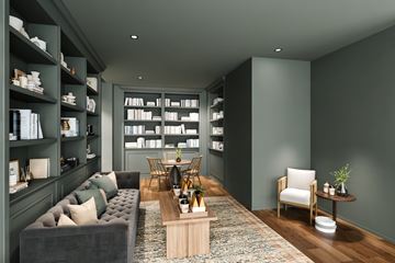 New Haven apartment for rent - A modern living room with a grey sofa, a wooden coffee table, and a bookshelf filled with books.
