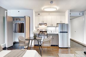 Seattle apartment for rent - A modern kitchen with a table and chairs in the middle.