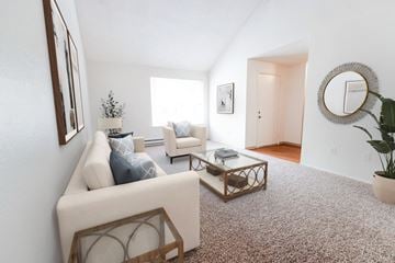 Steilacoom apartment for rent - A living room with a white couch and a coffee table.