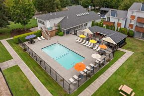Tacoma apartment for rent - A pool surrounded by a fence and chairs. at Northpoint Apartments, Tacoma