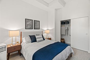 A bedroom with a bed and a closet
