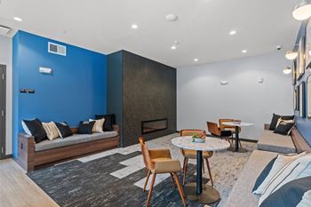 A living room with a blue accent wall and a fireplace