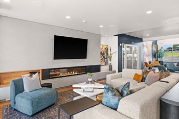 A living room with couches and chairs and a fireplace