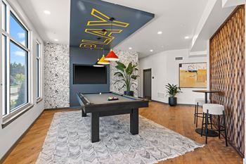 A game room with a pool table and a tv