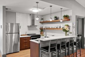 Tacoma apartment for rent - A modern kitchen with a stainless steel refrigerator and a white countertop. at Northpoint Apartments, Washington
